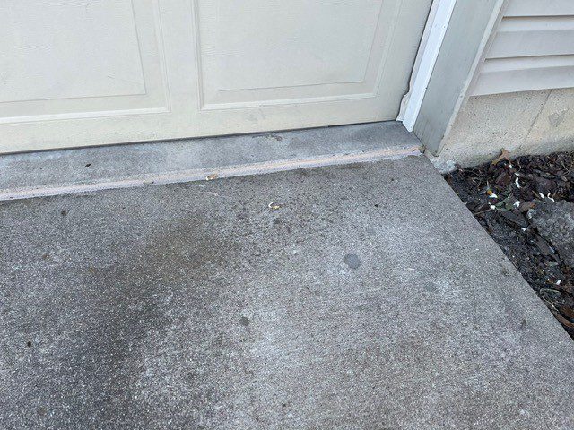 Concrete slab where it meets a garage door threshold