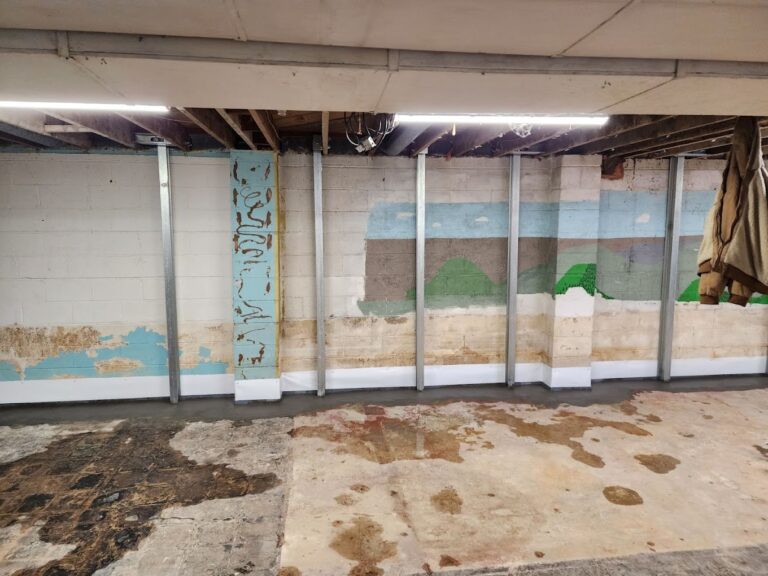 Steel power braces installed along a basement block wall
