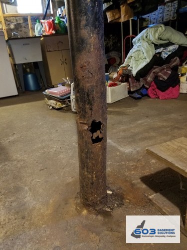 Steel lally column rusted through near the slab