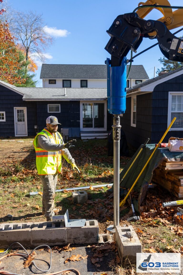 603 crew installing a helical pier at a New Hampshire home