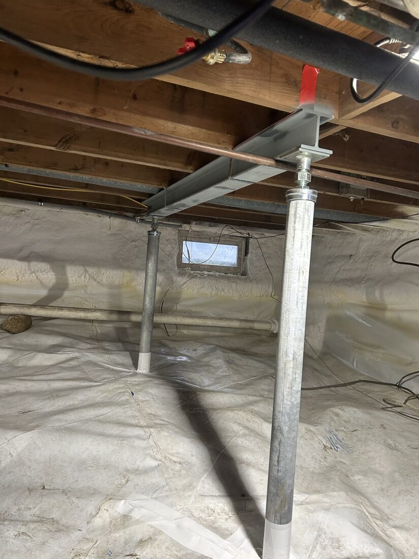 New steel I-beam carrying the joists on two galvanized columns, spray-foamed rim, sealed liner. Same crawl space as la